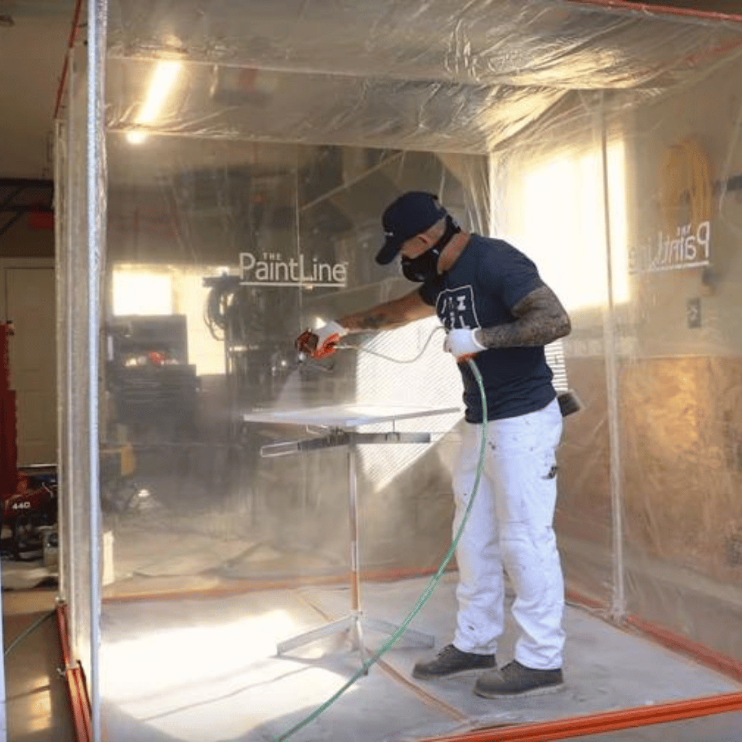 Man painting a door on Spray Twirly Rotating Paint Stand