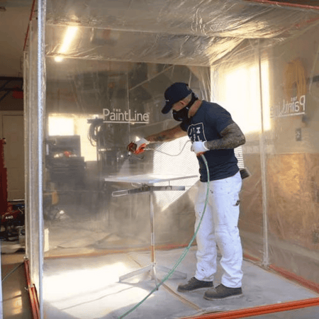 Man painting a door on Spray Twirly Rotating Paint Stand