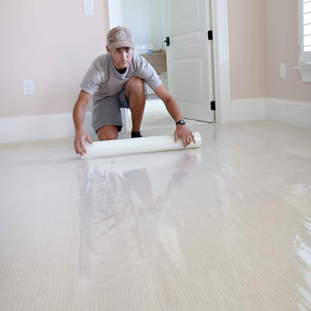 contractor applying carpet protection film in residential room