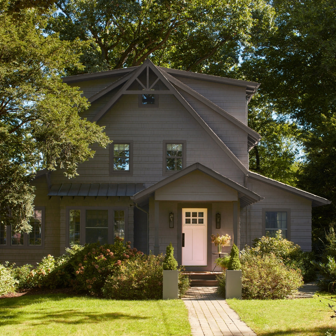 Dark home painted in Benjamin Moore Iron Mountain with Georgia Pink front door using Regal Select Exterior