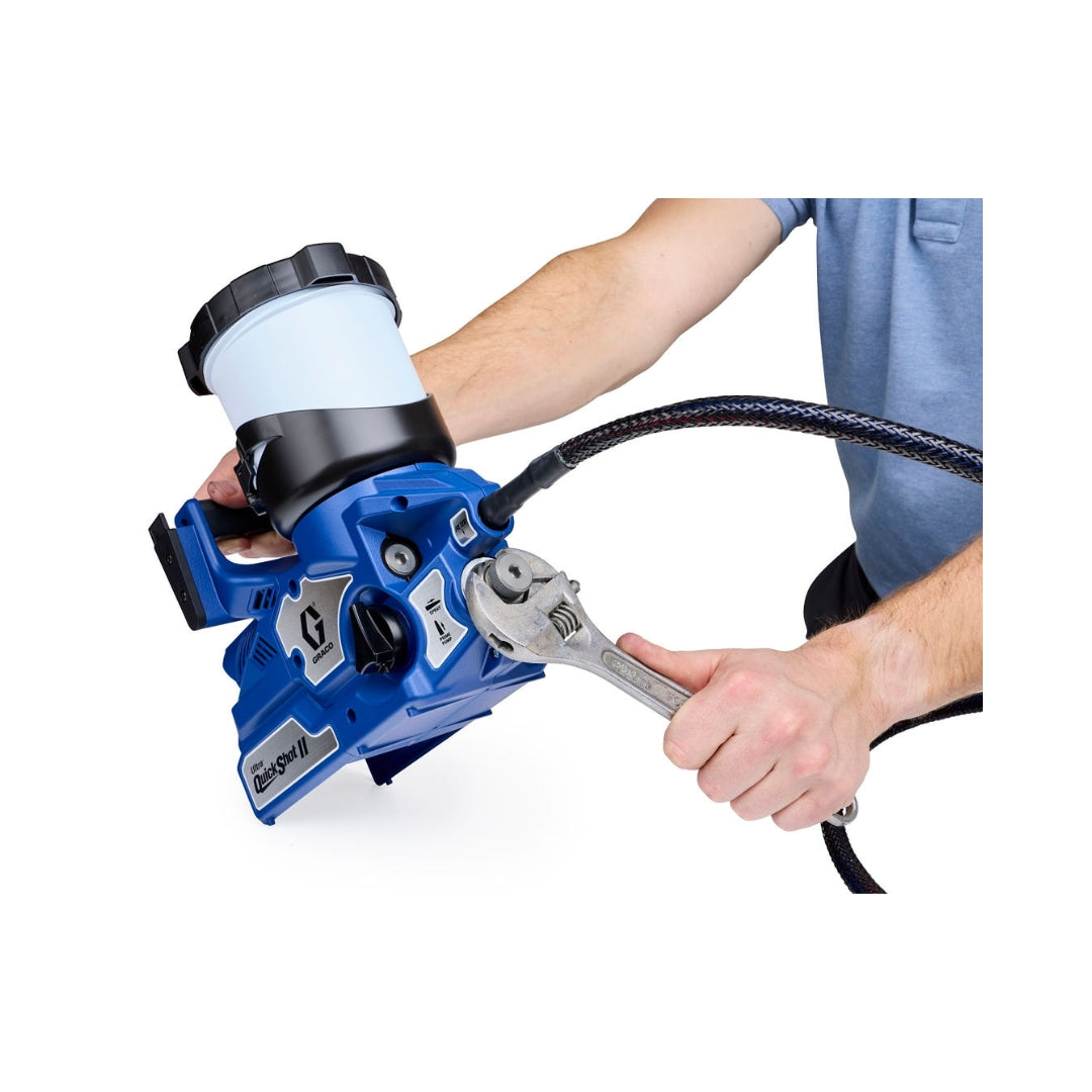 Contractor servicing inline filter on Graco Ultra QuickShot II cordless paint sprayer