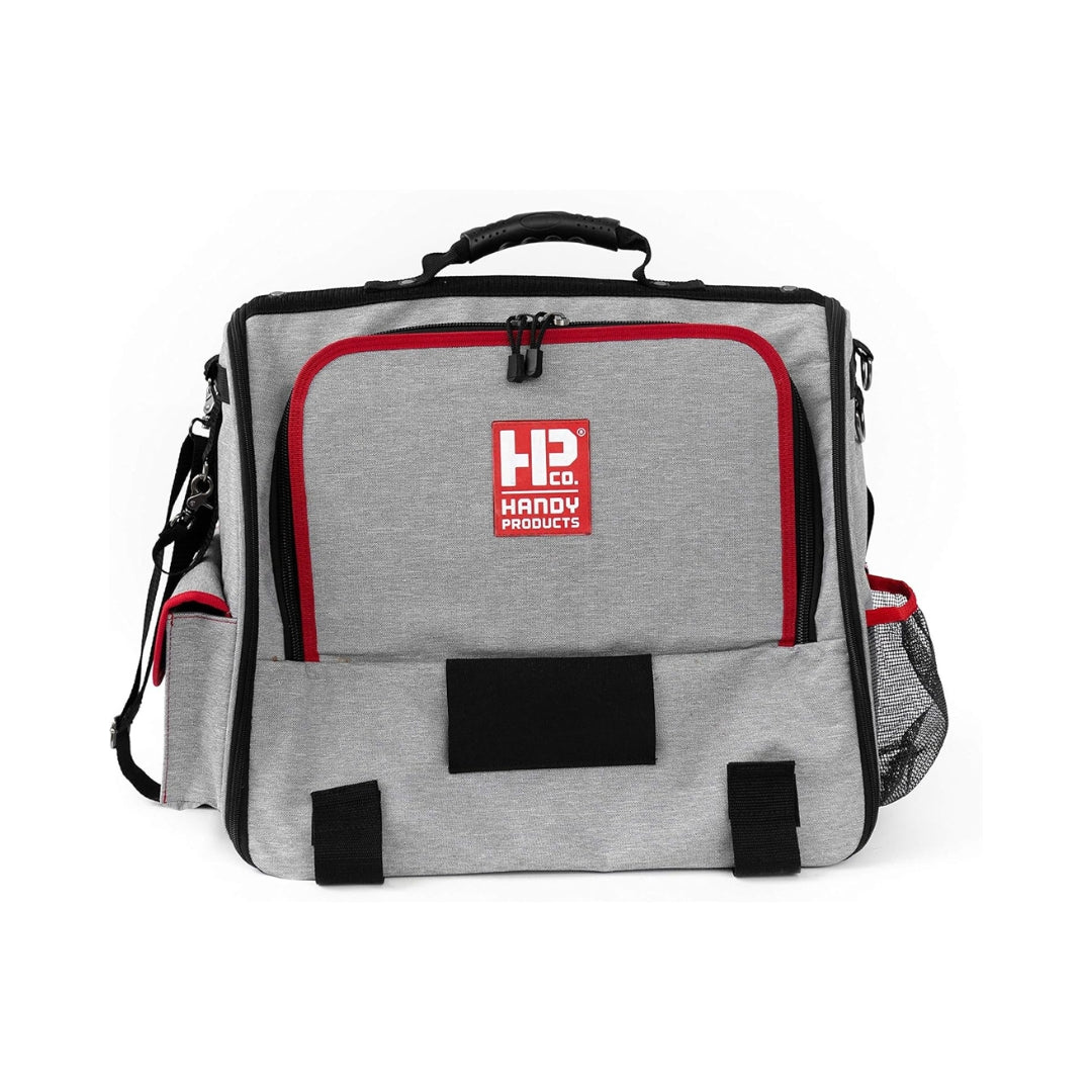 Interior compartments of Handy Painters Tool Bag Deluxe showing brush slots and red liner for organized storage.