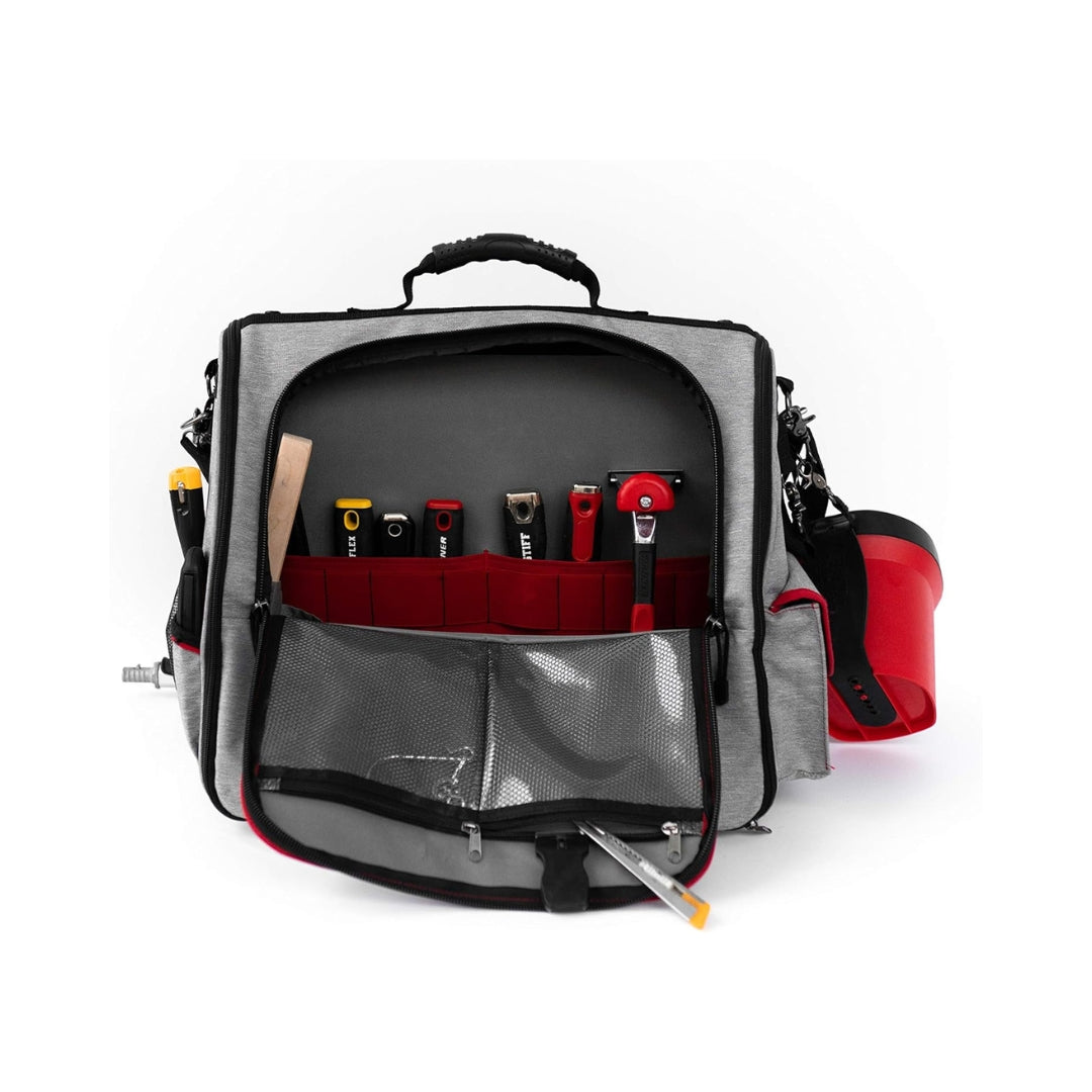 Painter loading Handy Painters Tool Bag Deluxe into work van with painting equipment and accessories.