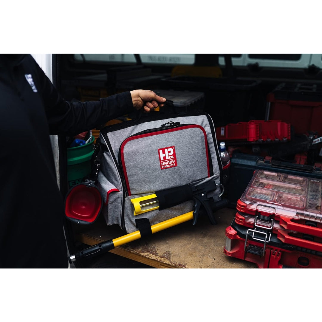 Side profile of Handy Products Painters Tool Bag Deluxe with adjustable straps, pockets, and attached tools.