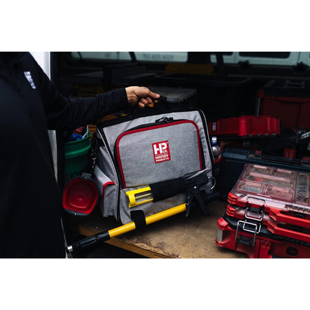 Side profile of Handy Products Painters Tool Bag Deluxe with adjustable straps, pockets, and attached tools.