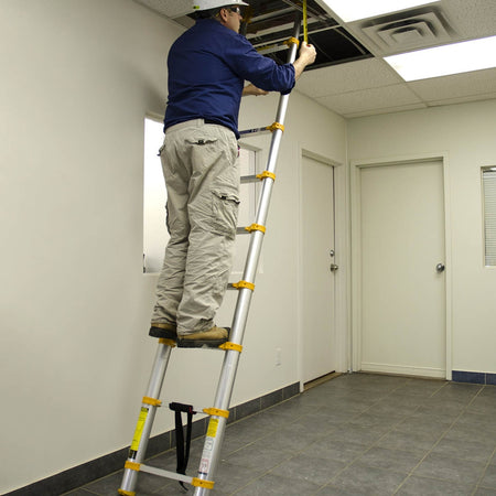 Contractor using the Metaltech telescopic ladder indoors to access ceiling area