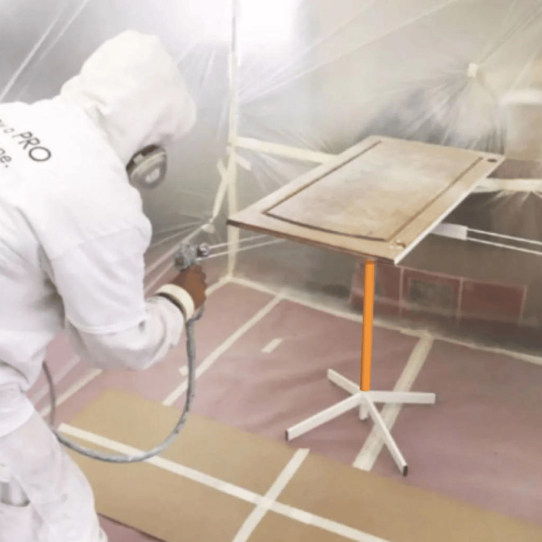 professional painter painting a door on rotating paint stand table